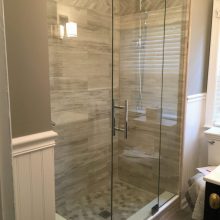 Tub to Shower Conversion creating an oversized shower, bead board trim, frameless shower door, grey tile