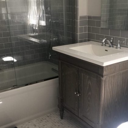 Hallway Bathroom Makeover - New Glass Shower Sliding Door over Tub, Grey subway tiles, feminine gray vanity,