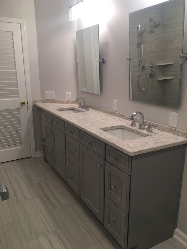 New Vanity With Grey Cabinetry and Angled Corner Top