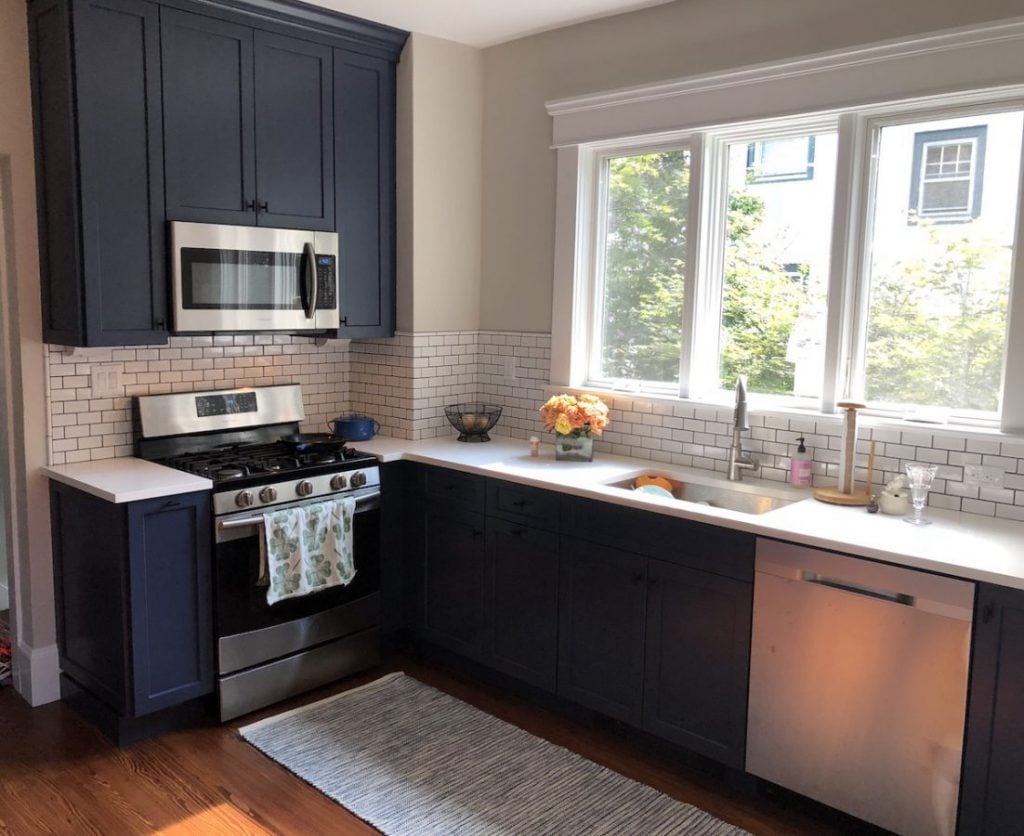 Tall, Narrow Navy Cabinetry and White Quartz Countertops