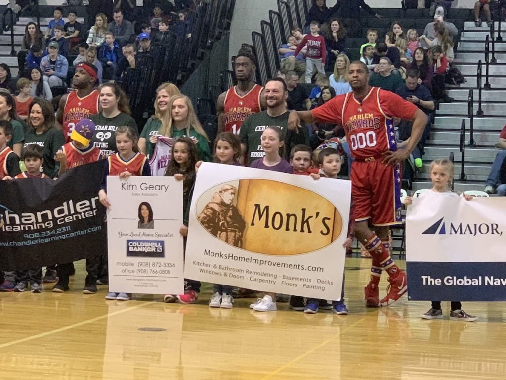 Monk children with Principal Ciempola and Wizards players