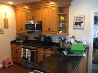 Oak Cabinetry with Black Countertops