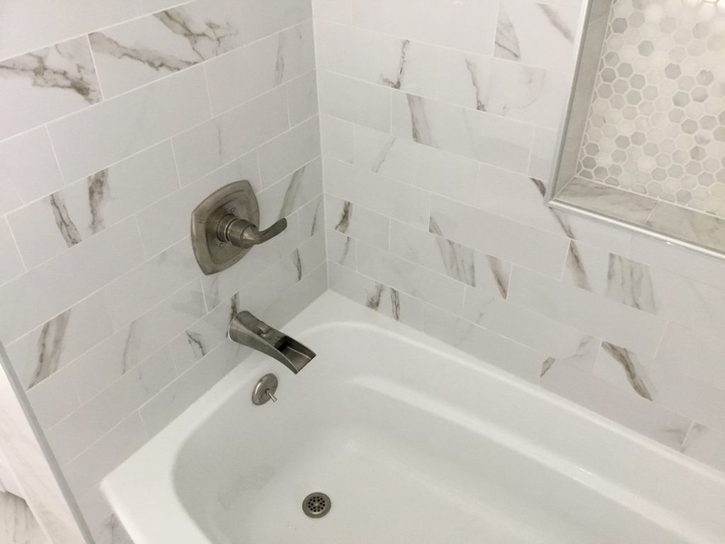 Marble Look Tile with Niche over Tub