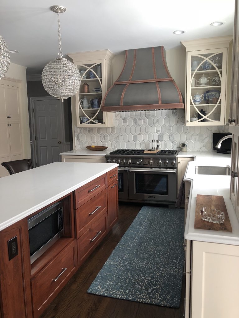 Cherry island with antique white wall cabinets