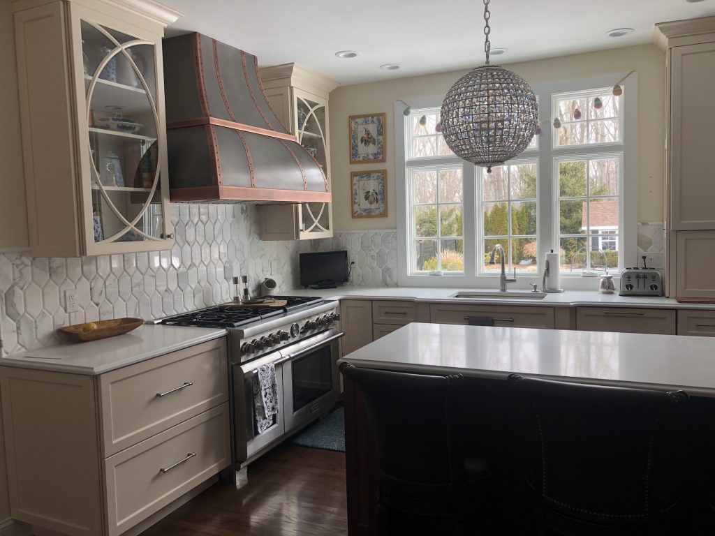 Three windows behind the kitchen sink