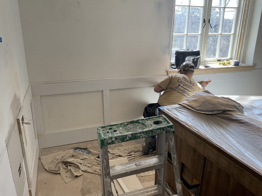 Monk's carpenters installing the wainscoting